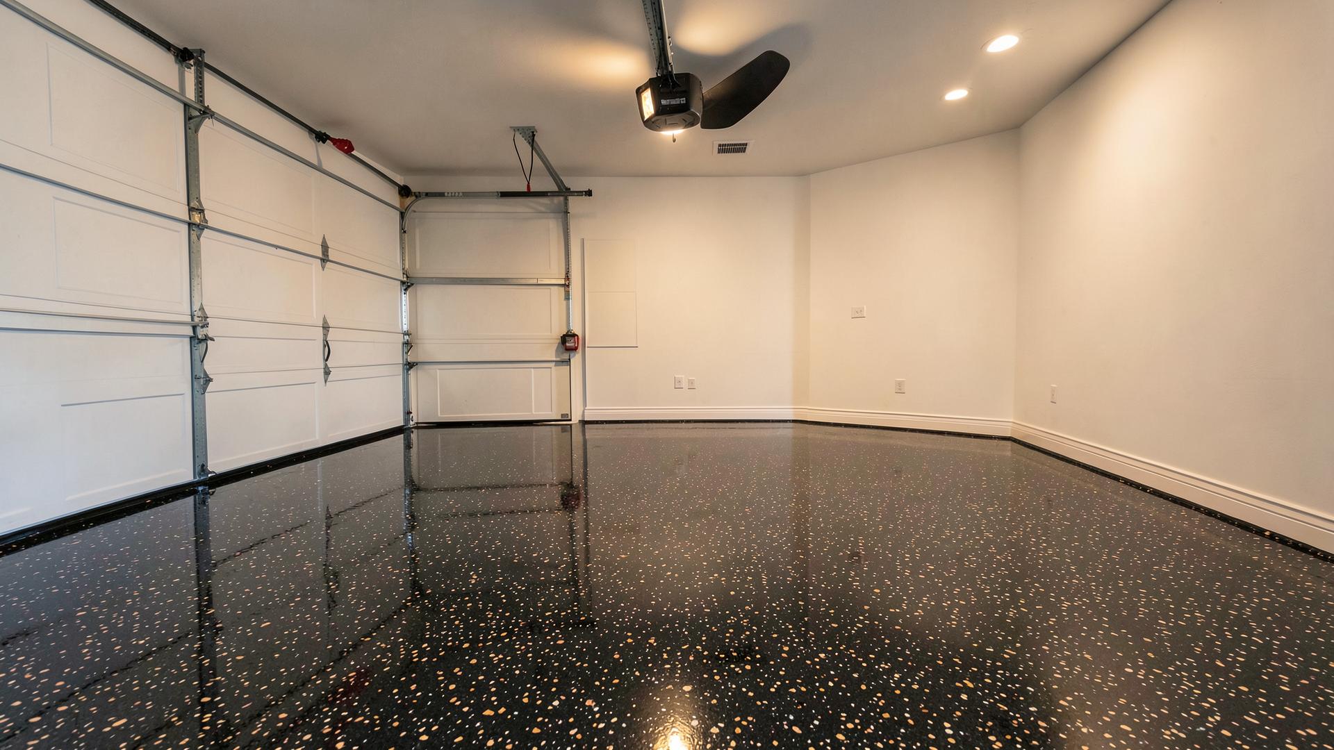 Two-car garage with a dark flake epoxy floor and glossy clear topcoat